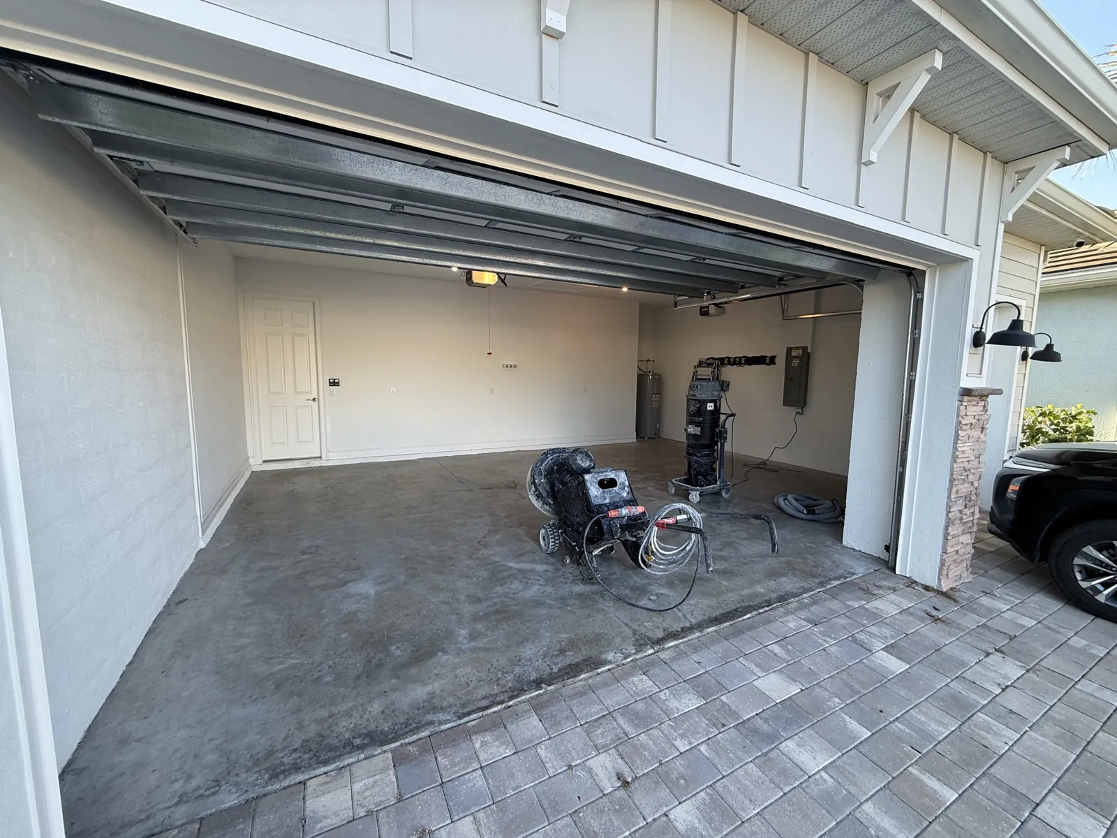 Before — Bare concrete with diamond grinding equipment on site