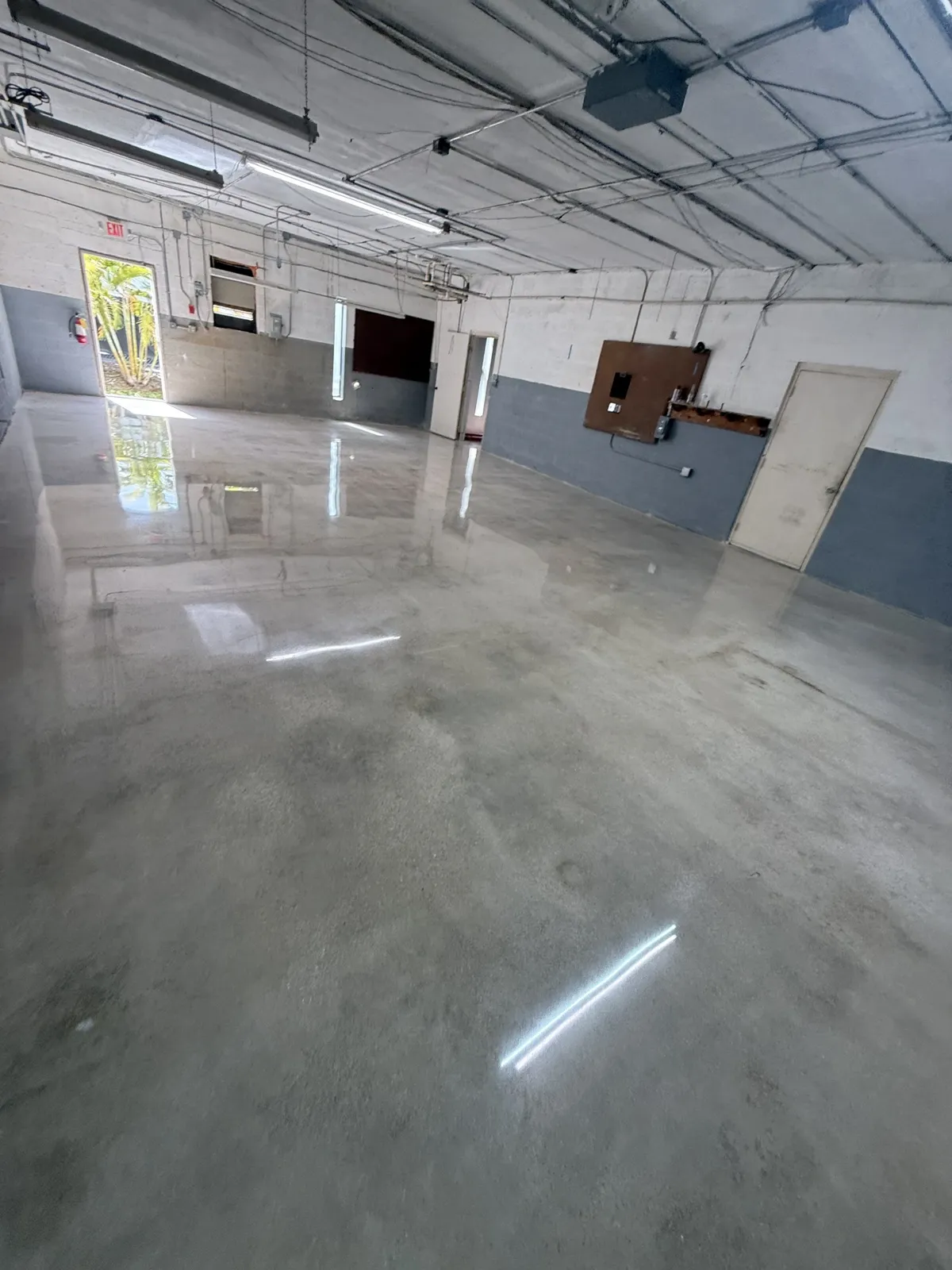 After — Open room with natural polished concrete finish
