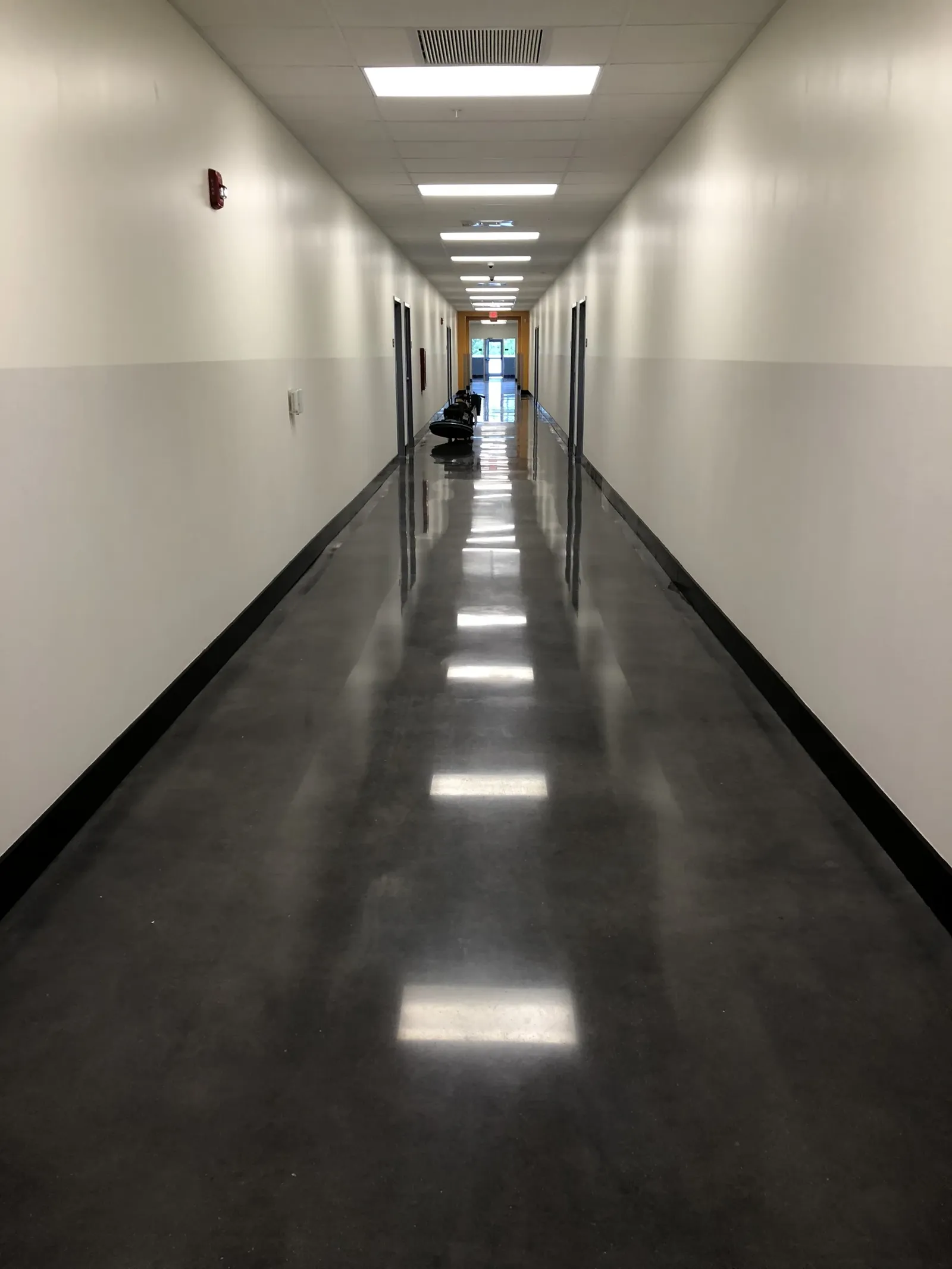 After — Charcoal-dyed corridor, burnished to a shine