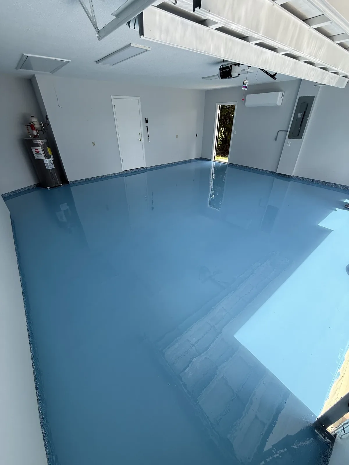 Process — 100% solids epoxy base coat flooded over the prepared slab