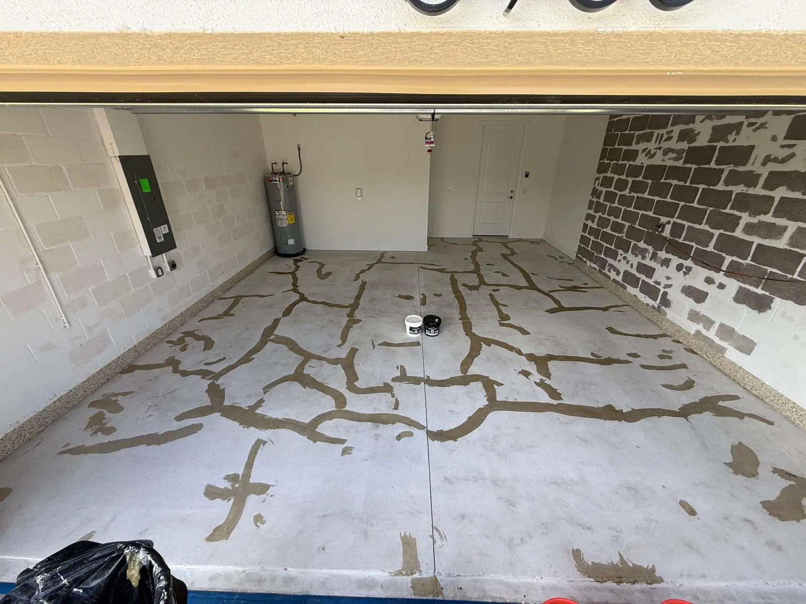 Concrete crack repair Naples FL - garage floor cracks marked for professional repair